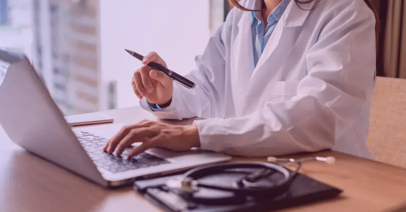 doctor working on a laptop