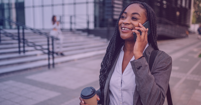 business woman walking down the street while on a phone call