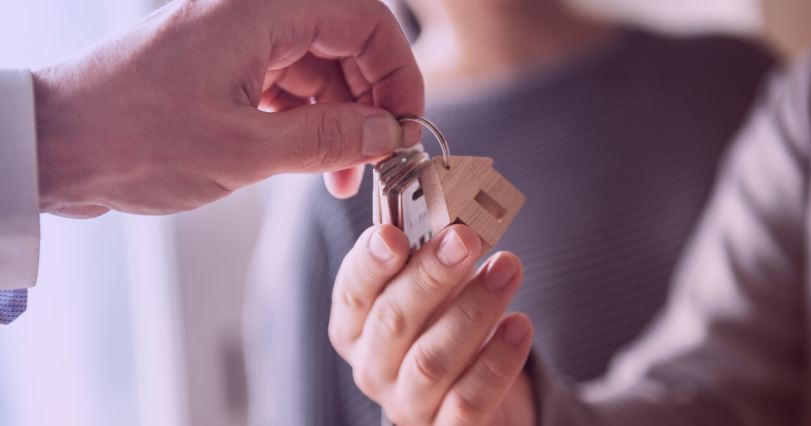 real estate agent handing keys over to a buyer