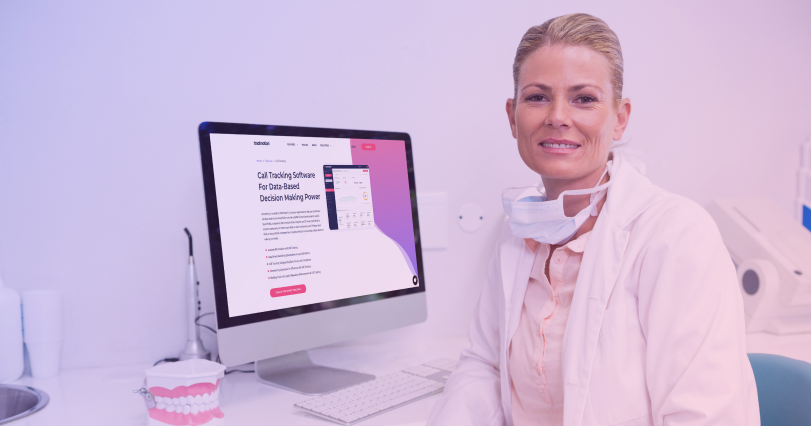 A dental receptionist in front of her computer looking at TrackNotion's call tracking benefits.